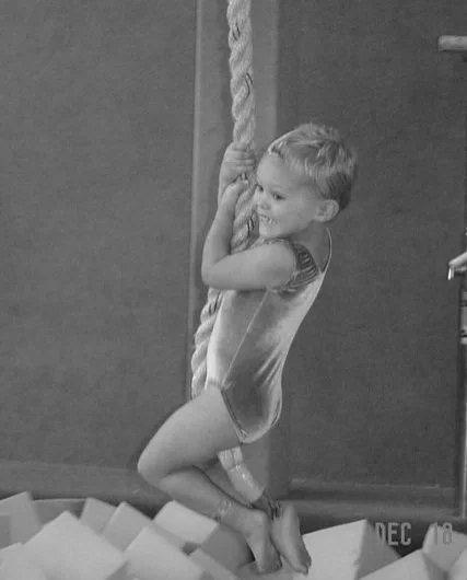Young Mia climbing a rope